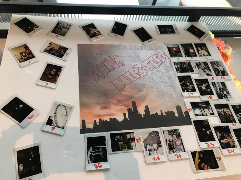 A themed display board titled 'Team Asian Hipsters' from a Polaroid scavenger hunt, featuring a central image of the Chicago skyline at sunset. The board is surrounded by numbered Polaroid photos capturing moments from the scavenger hunt challenges, arranged in a creative and organized layout. The display highlights teamwork and creativity during this engaging and fun-filled team building activity.