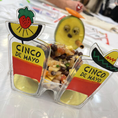 A Cinco de Mayo-themed dish with a creative presentation featuring glasses decorated with fruit and a playful garnish, showcasing the fun and festive atmosphere of the Salsa Showdown team building event.