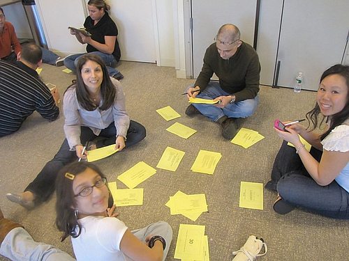 Team members collaborate on problem-solving challenges during a Big Give team building event, preparing for the charity-focused activities ahead.