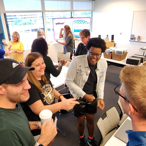 Team members share a moment of laughter and connection during a Hopefull Handbags Global team building event.