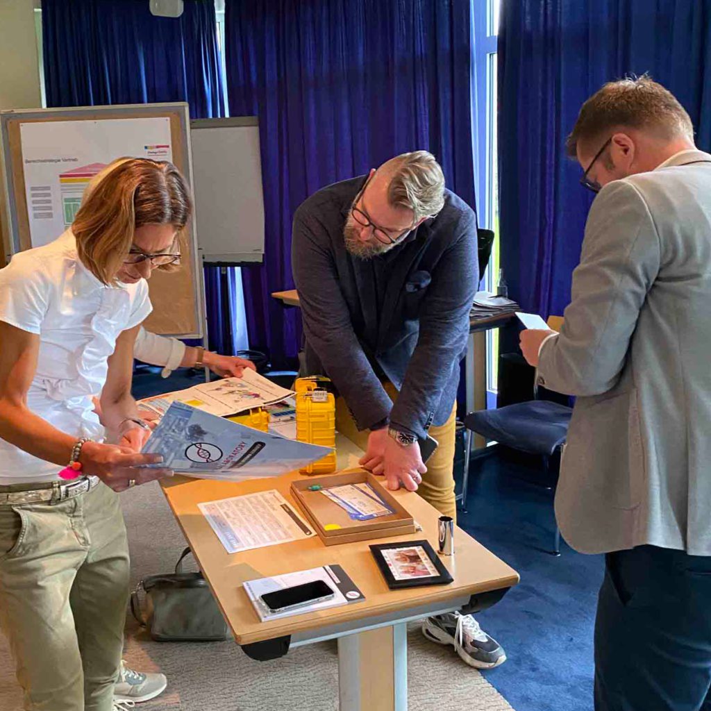 Team members collaborating and reviewing clues during the 'Atmosphere' team building event, focusing on solving puzzles to unlock the next challenge.