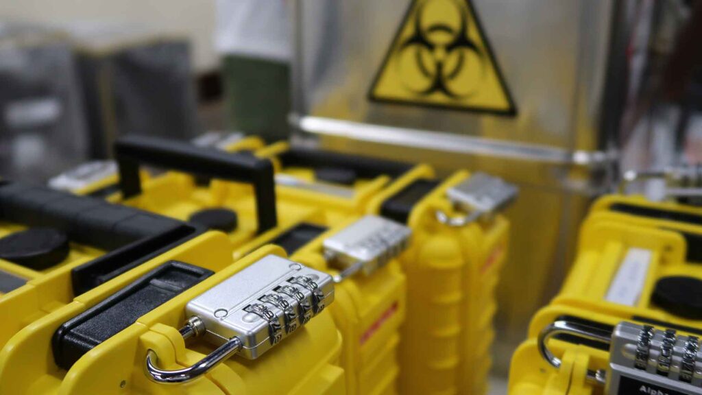 Yellow lockboxes with combination locks and biohazard symbols used in the 'Atmosphere' team building event.