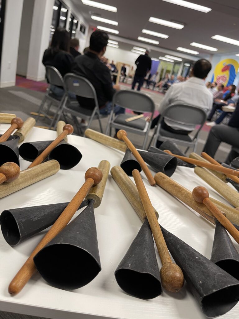 Close-up of cowbells and drumsticks on a table, ready for use in a BeatsWork team building drumming session.