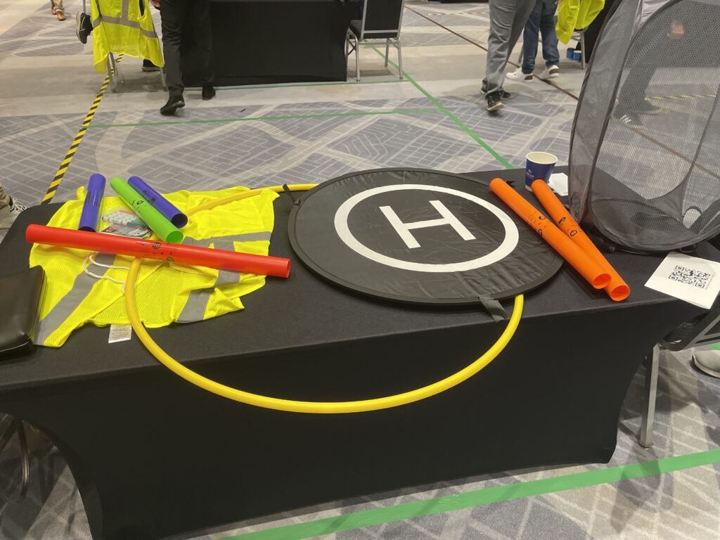 Colorful props, landing pads, and tools are set up for participants to navigate their drones during the Game of Drones team building event.